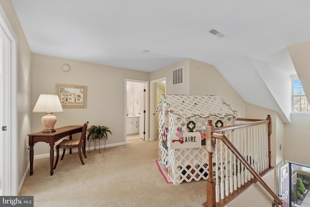 bedroom with vaulted ceiling and light colored carpet