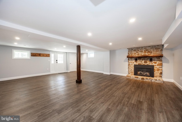 basement featuring dark wood-type flooring and a fireplace