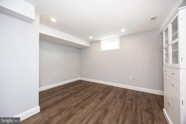 basement featuring dark hardwood / wood-style floors