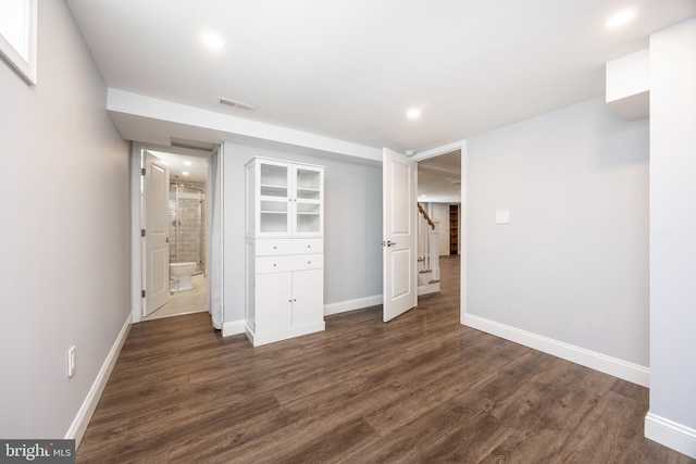 unfurnished bedroom with dark wood-type flooring