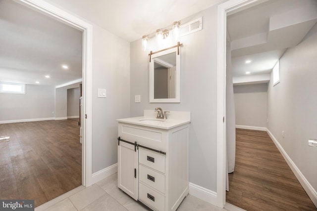 bathroom featuring vanity and hardwood / wood-style floors