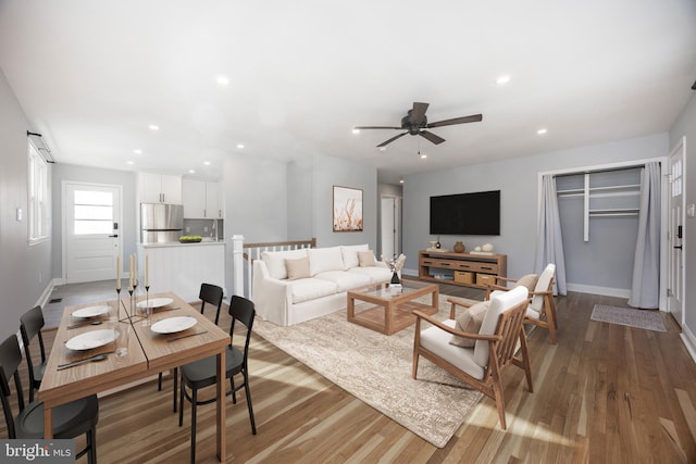 living room featuring ceiling fan and wood-type flooring