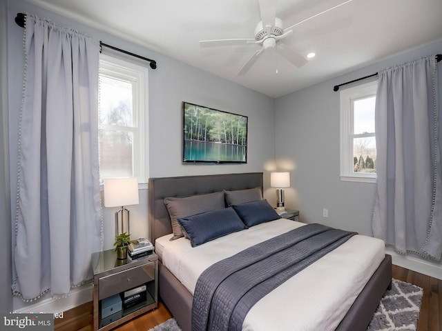 bedroom with hardwood / wood-style floors and ceiling fan