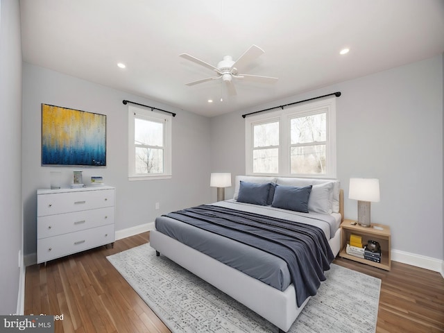 bedroom with dark hardwood / wood-style floors and ceiling fan