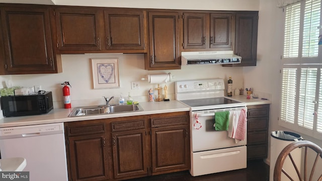 kitchen with sink, white appliances, and dark brown cabinets