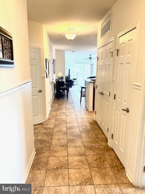 hallway featuring tile patterned flooring