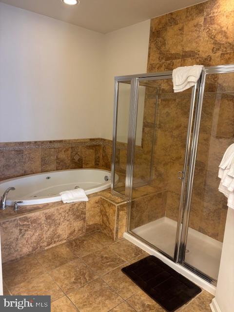 bathroom featuring separate shower and tub