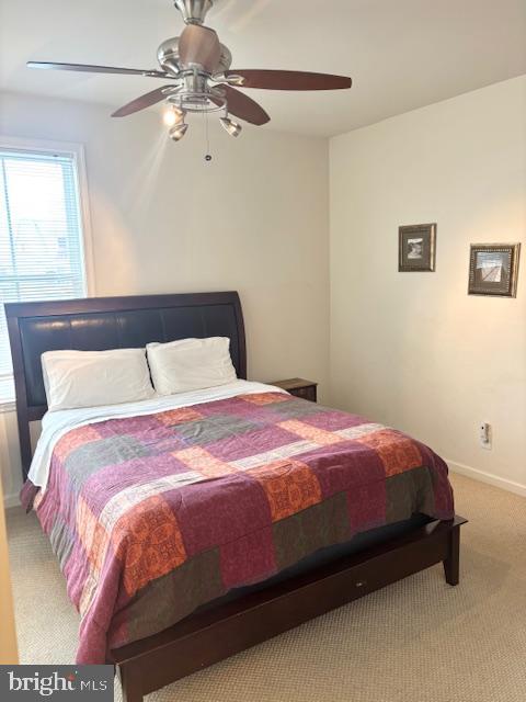 bedroom with ceiling fan and carpet flooring