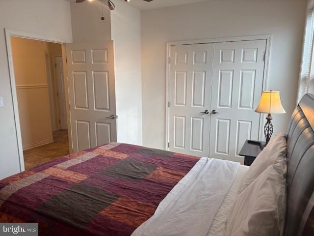 bedroom with ceiling fan and a closet