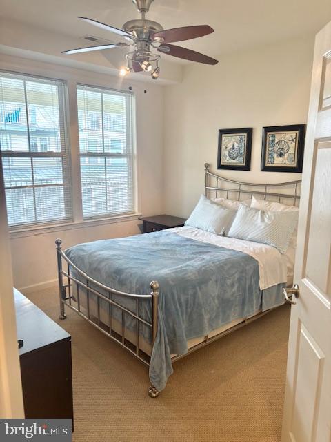 carpeted bedroom with ceiling fan