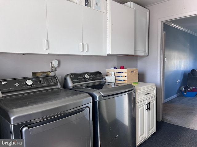 laundry room with washing machine and dryer and cabinets