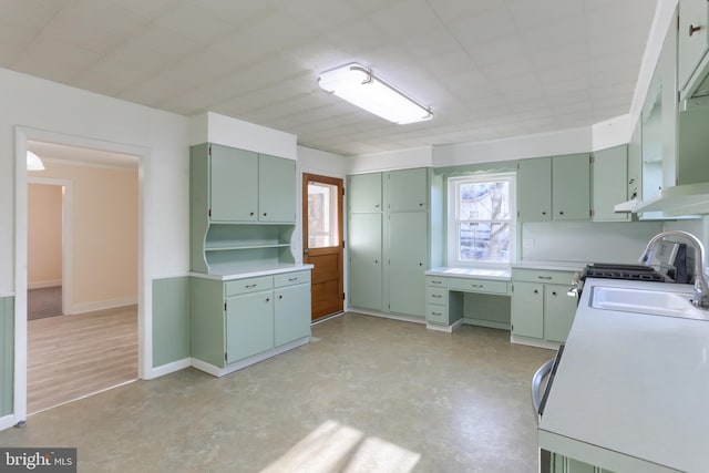 kitchen featuring sink, extractor fan, and green cabinets