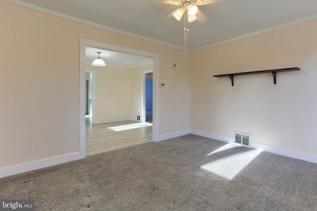 carpeted spare room featuring ornamental molding