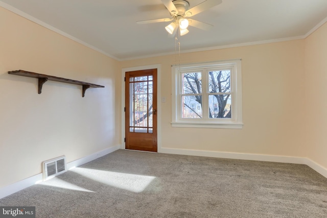 carpeted entryway featuring crown molding and ceiling fan