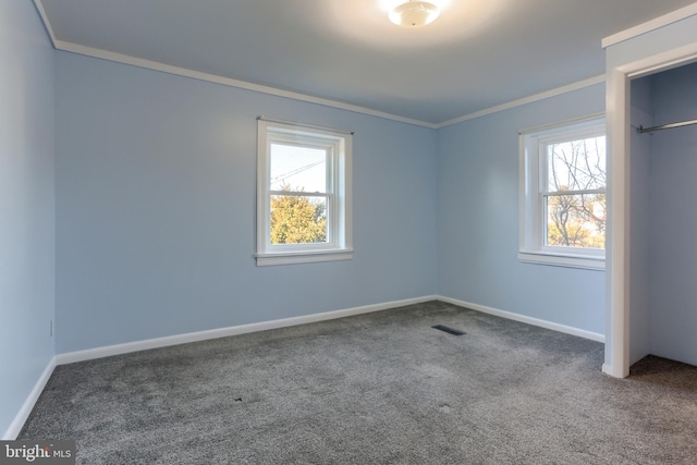 unfurnished bedroom with multiple windows, ornamental molding, and carpet