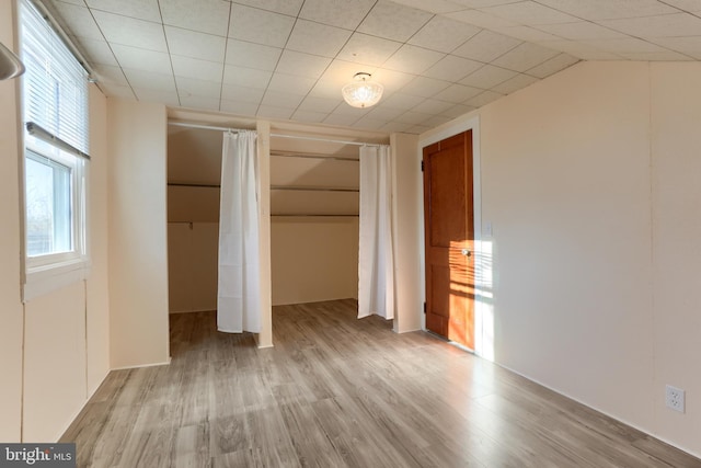 unfurnished bedroom with a closet and light hardwood / wood-style flooring