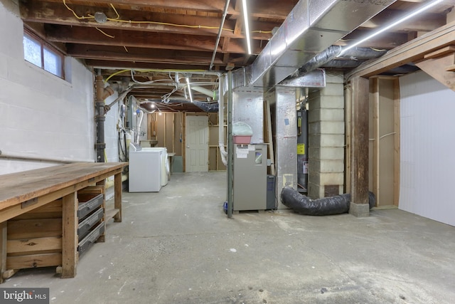 basement featuring washer / clothes dryer, heating unit, and water heater