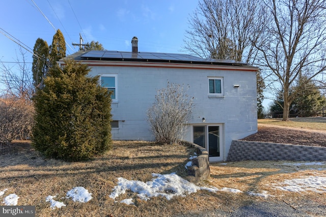 back of house with solar panels