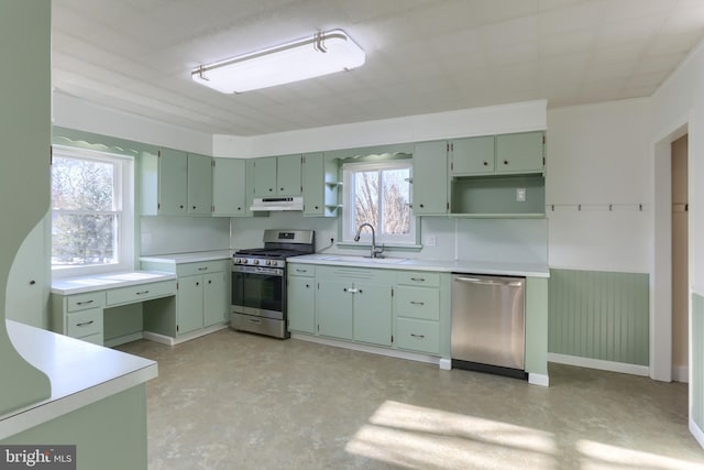 kitchen with green cabinets, appliances with stainless steel finishes, sink, and plenty of natural light