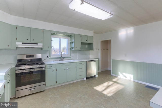 kitchen with green cabinetry, appliances with stainless steel finishes, and sink