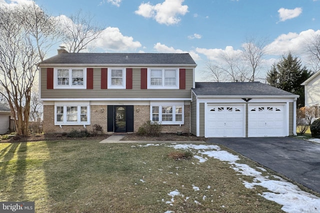 view of front of house with a garage and a front yard