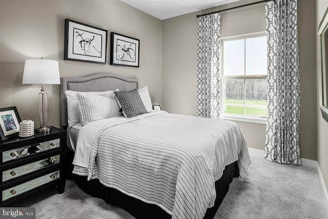 bedroom featuring light colored carpet