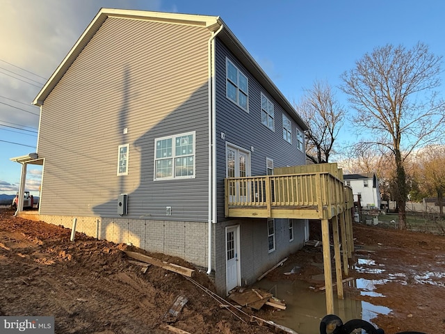 back of property with a wooden deck