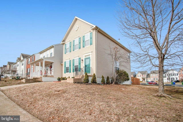 view of front facade with a front lawn and a porch