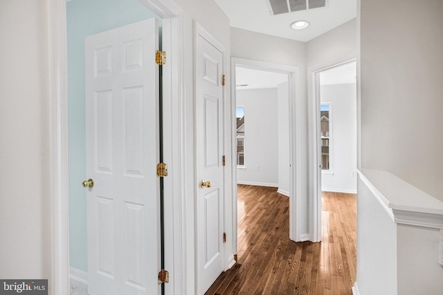 hallway with dark hardwood / wood-style flooring