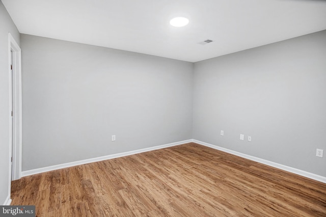 unfurnished room with wood-type flooring