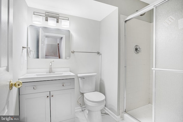 bathroom with an enclosed shower, vanity, and toilet