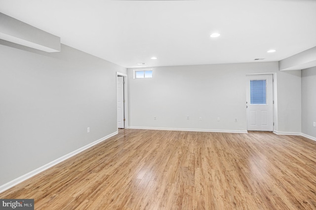 basement with light hardwood / wood-style flooring