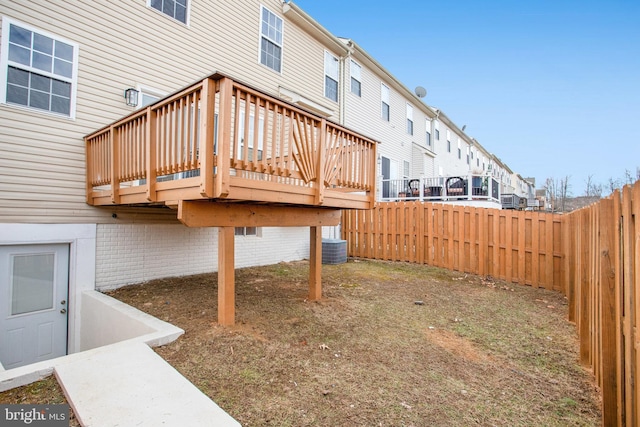 view of yard featuring cooling unit and a deck