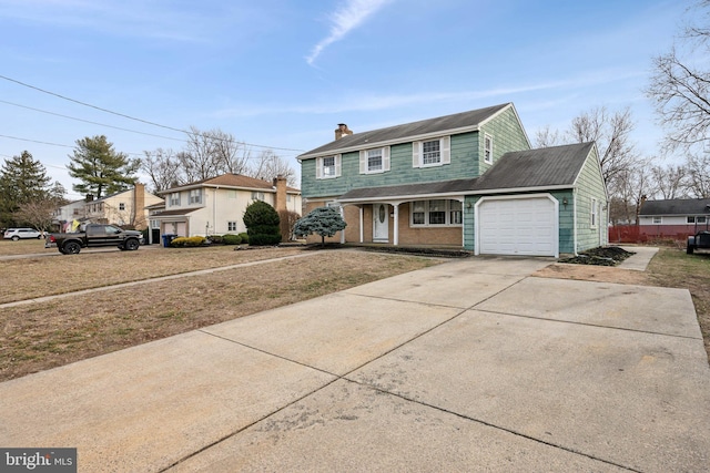 front facade featuring a garage and a front yard