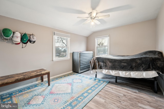 bedroom with lofted ceiling, light hardwood / wood-style flooring, and ceiling fan