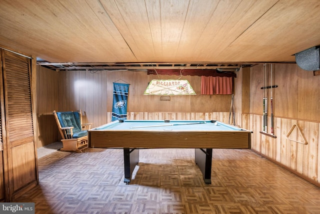 recreation room featuring parquet floors, pool table, and wood walls