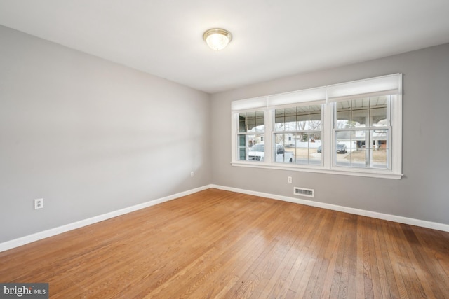 unfurnished room with hardwood / wood-style floors and a wealth of natural light