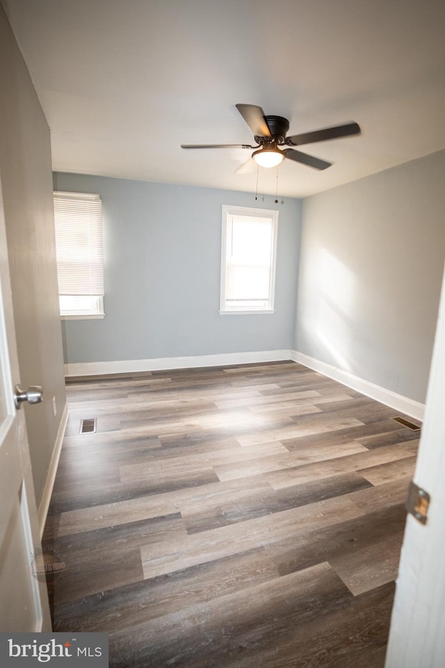 empty room featuring hardwood / wood-style floors and ceiling fan