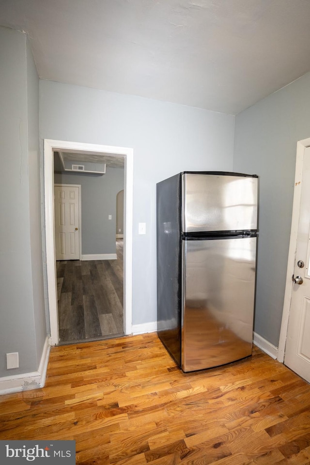 kitchen with stainless steel fridge and light wood-type flooring