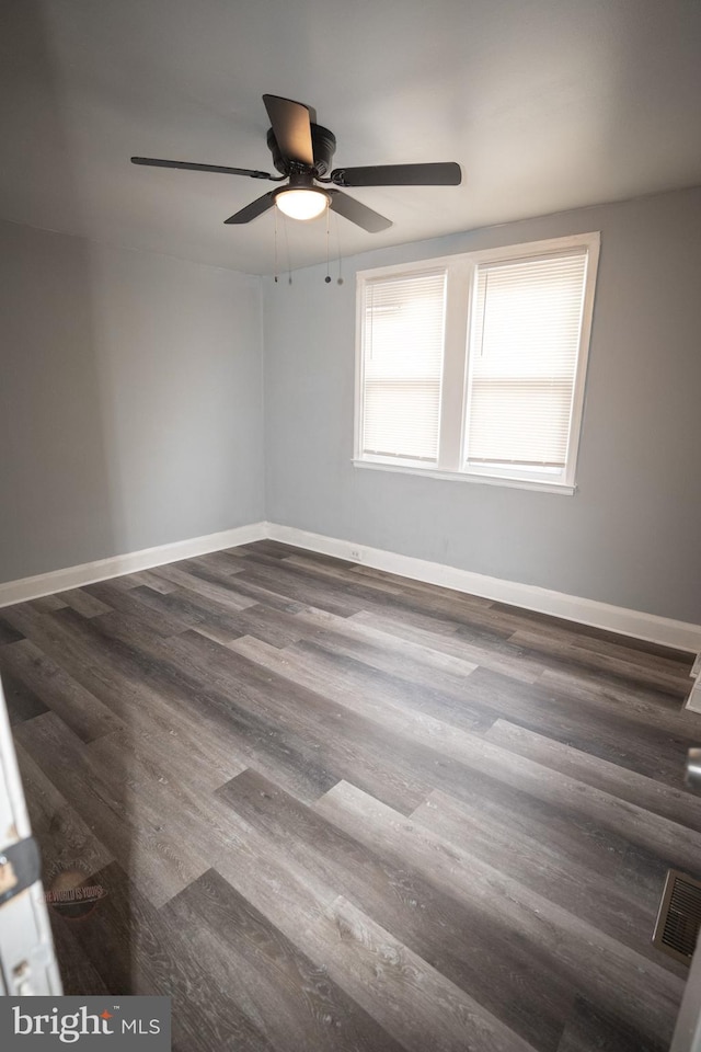 spare room featuring ceiling fan and dark hardwood / wood-style flooring