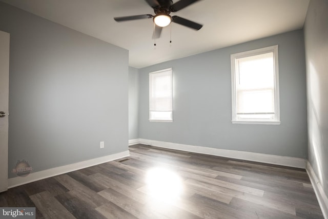 empty room featuring ceiling fan and dark hardwood / wood-style flooring