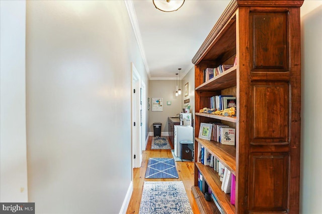 hallway featuring light hardwood / wood-style flooring and ornamental molding