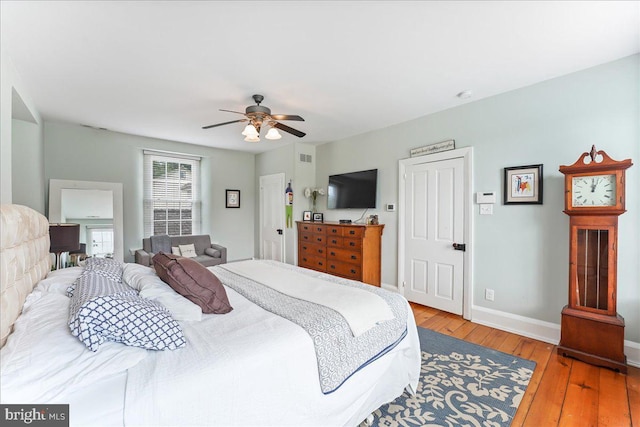 bedroom with ceiling fan and hardwood / wood-style floors