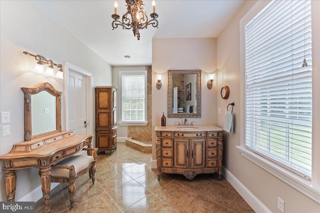 bathroom featuring vanity, tile patterned flooring, and a notable chandelier