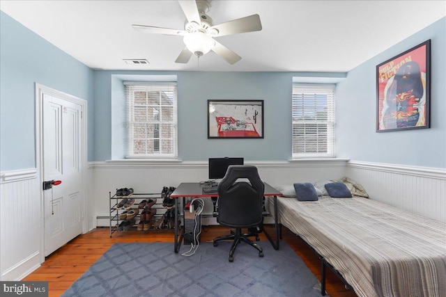 bedroom featuring hardwood / wood-style floors and ceiling fan