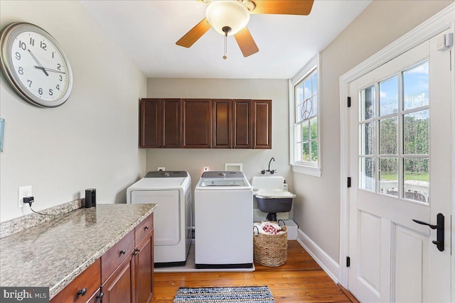 washroom with washing machine and clothes dryer, sink, cabinets, ceiling fan, and light hardwood / wood-style floors