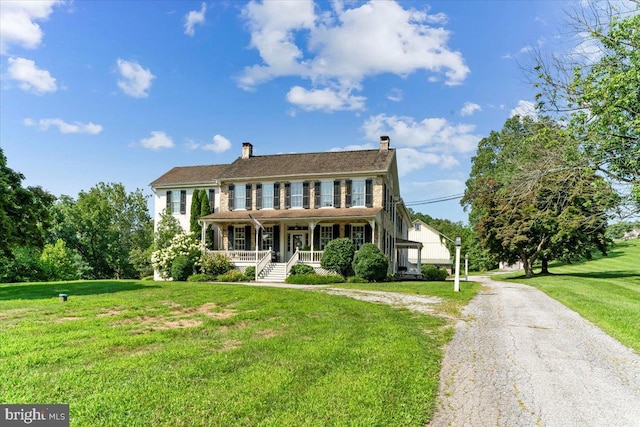 colonial house with a porch and a front yard