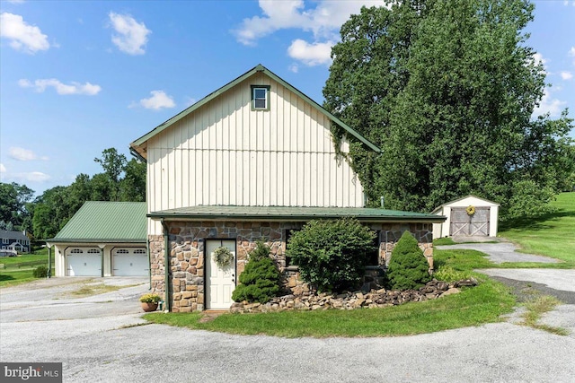 view of side of property featuring a storage unit and a garage