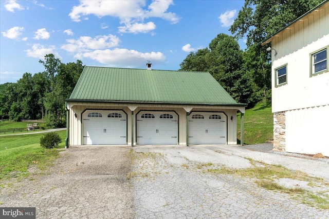 garage featuring a lawn