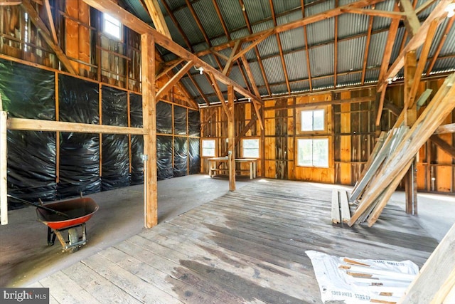 miscellaneous room featuring wood-type flooring and vaulted ceiling